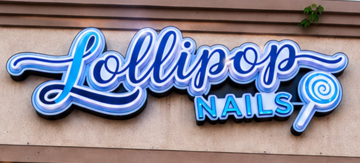 The real illuminated Lollipop Nails storefront sign